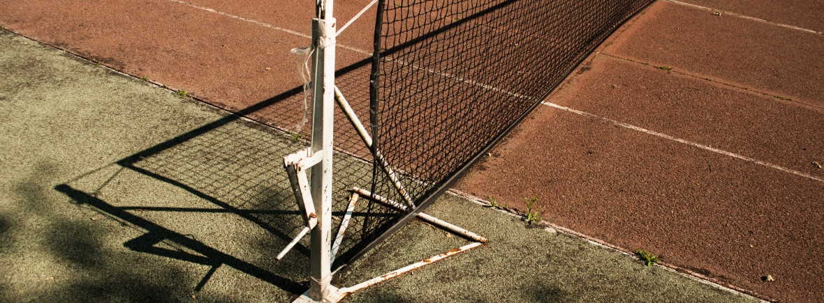 old tennis net spanning a court